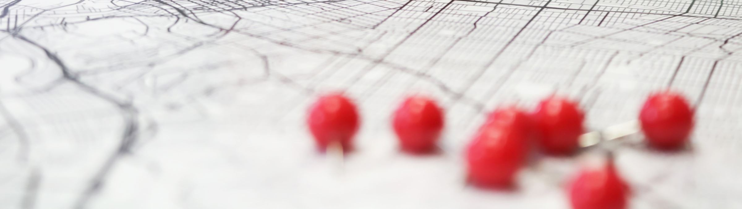 Planning graphic image of red pins on a map