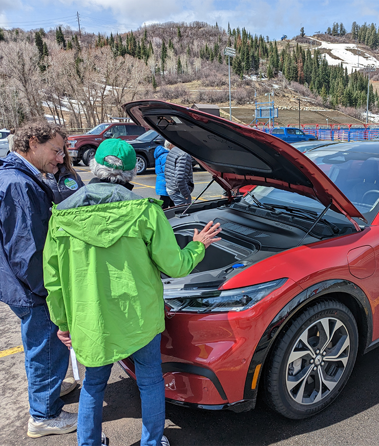Individuals check out an electric vehicle during free event