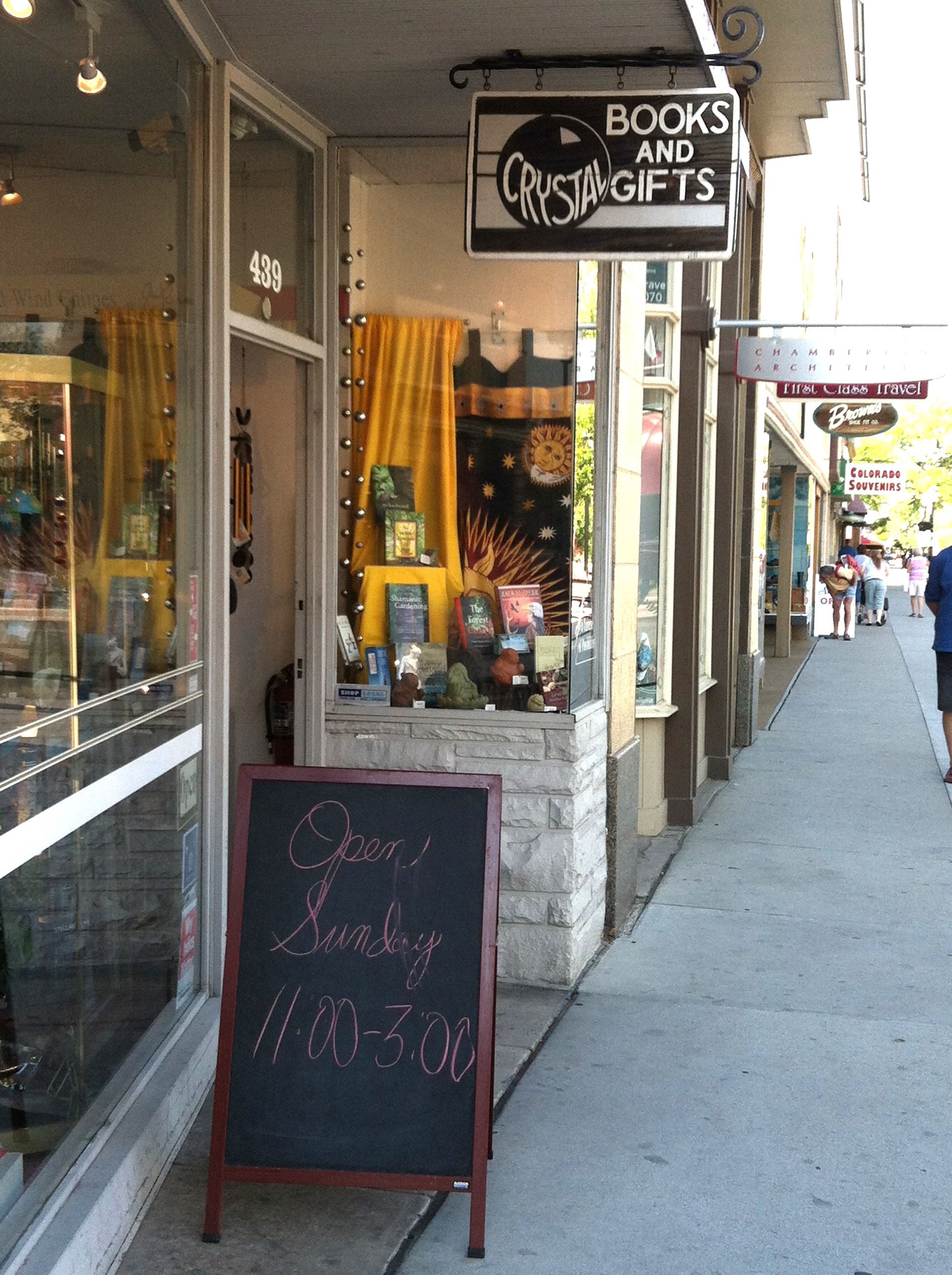 Portable sign in front of a bookstore with the hours of operation